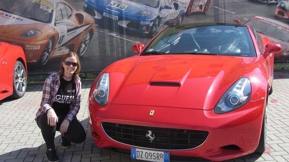 Corina Schmiedt in front of a car